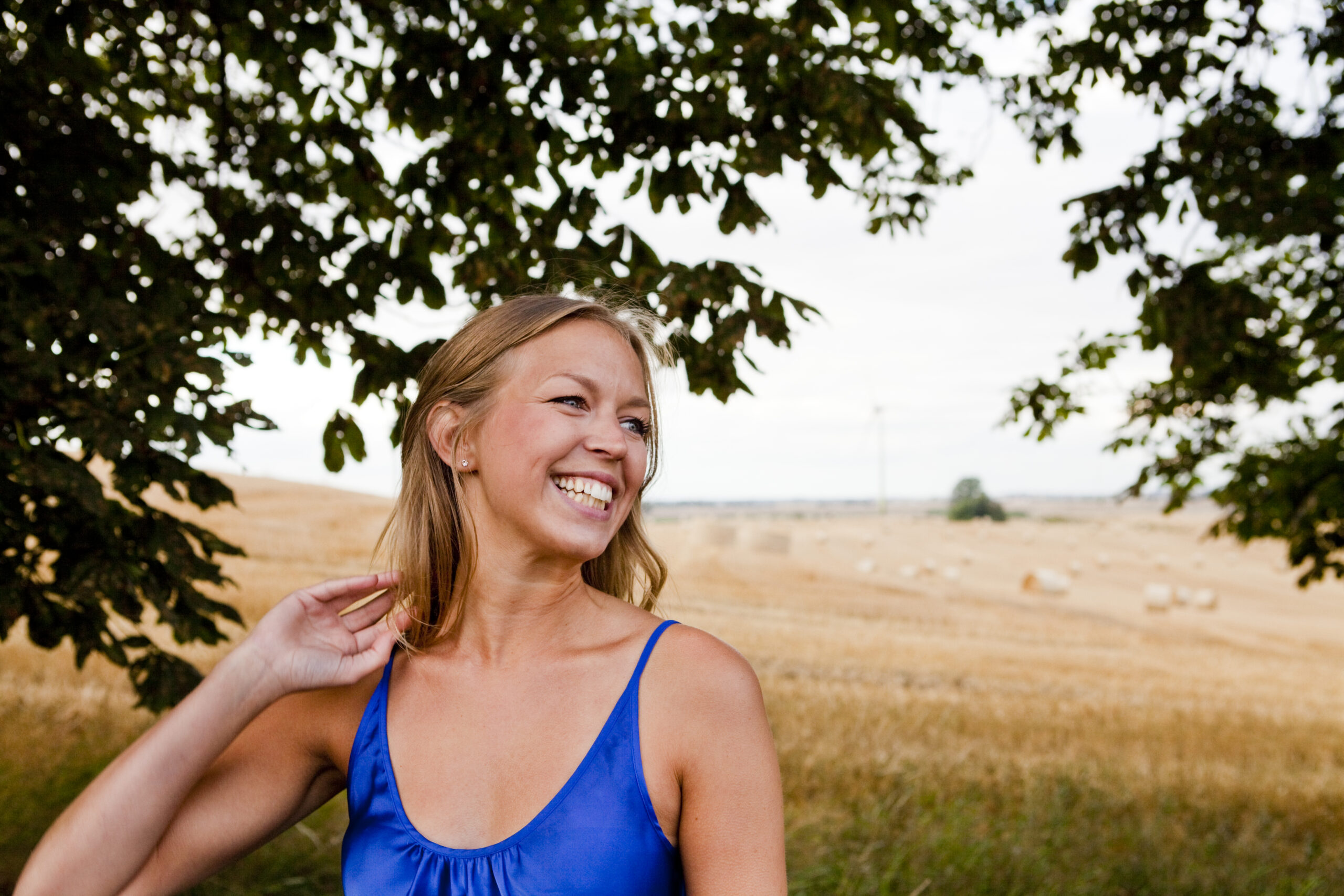 Cheerful woman looking away while standing on field prescription drug rehab