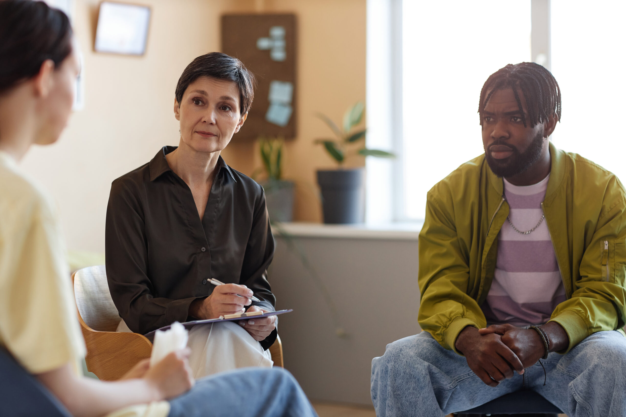 Psychologist working with people at session