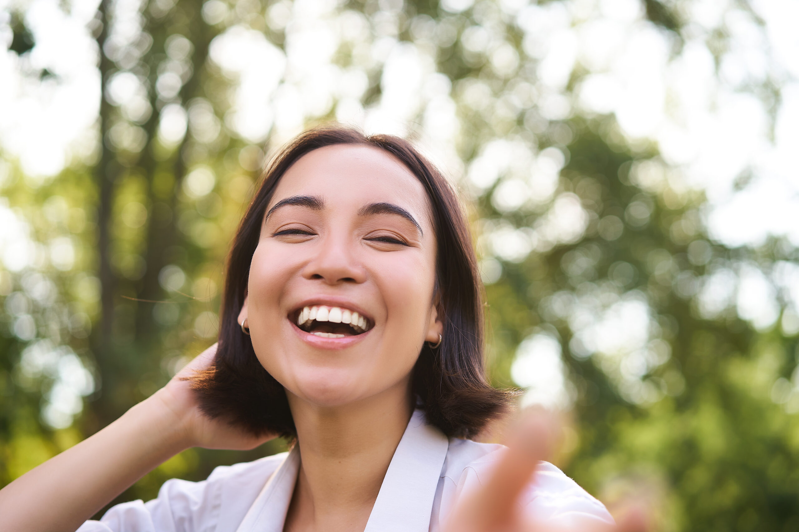 Genuine people. Portrait of asian woman laughing and smiling, walking in park, feeling joy and positivity